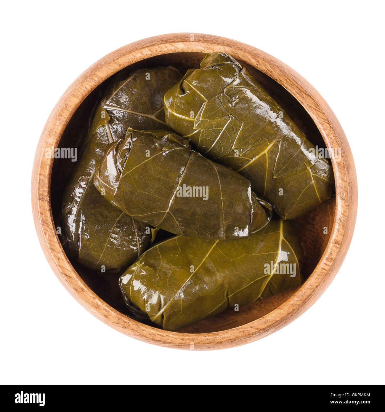 Dolma, stuffed vine leaves in a bowl on white background. Sarma in Turkish or Dolmades in Greek cuisine. Stock Photo