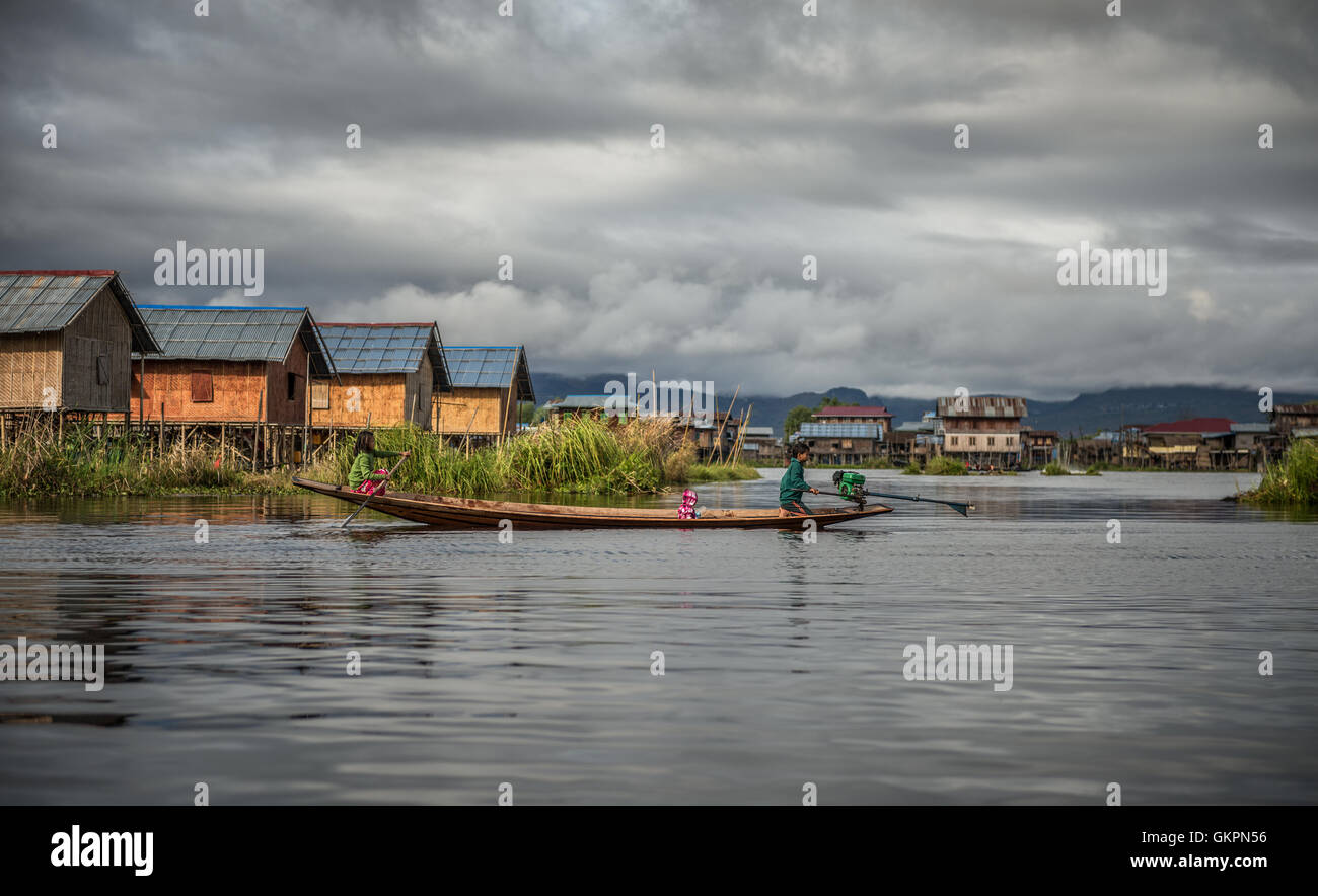Children of the Inthar tribe  boating through their village Stock Photo