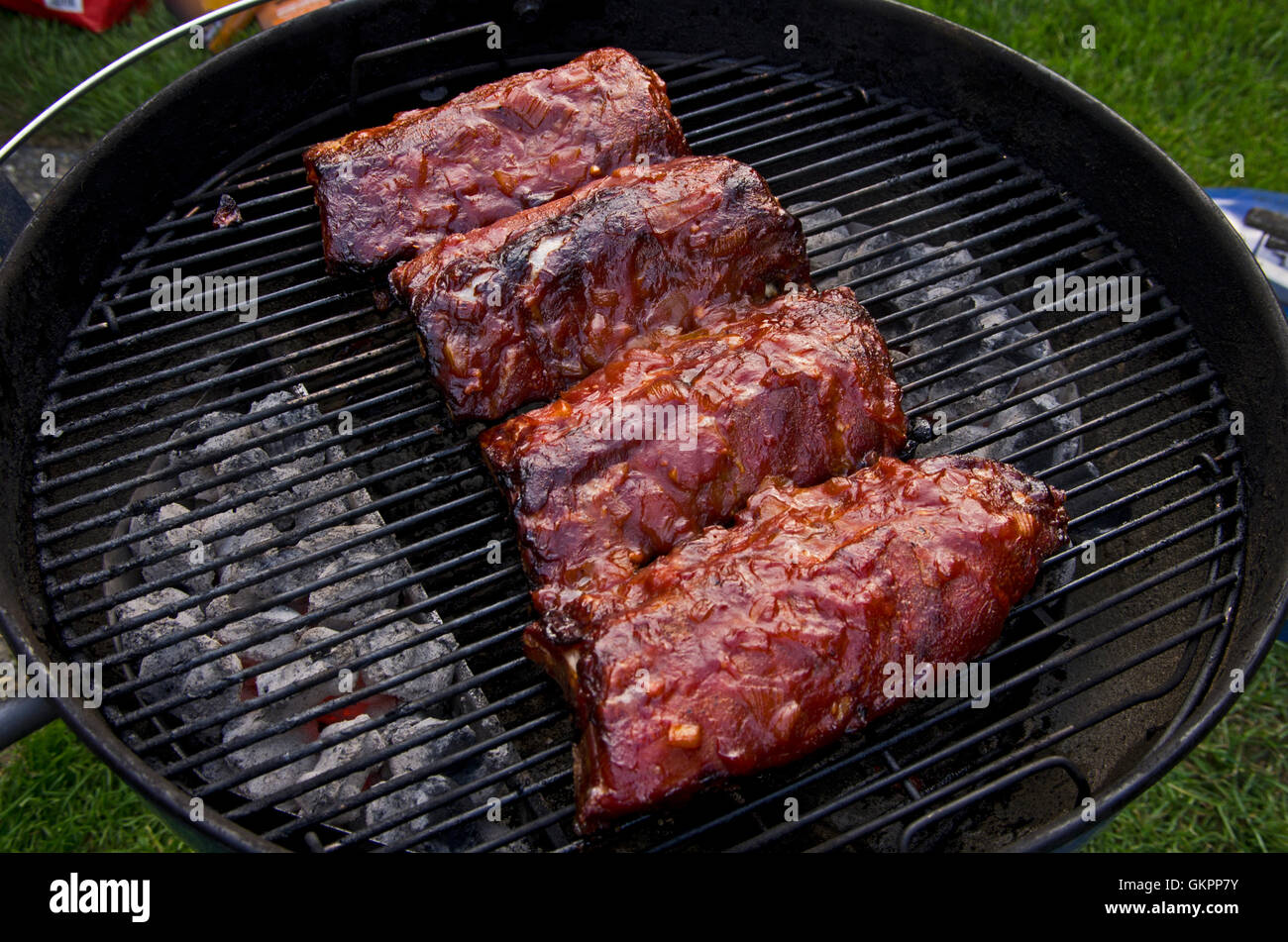 Pork baby back ribs  on a charcoal barbecue Stock Photo