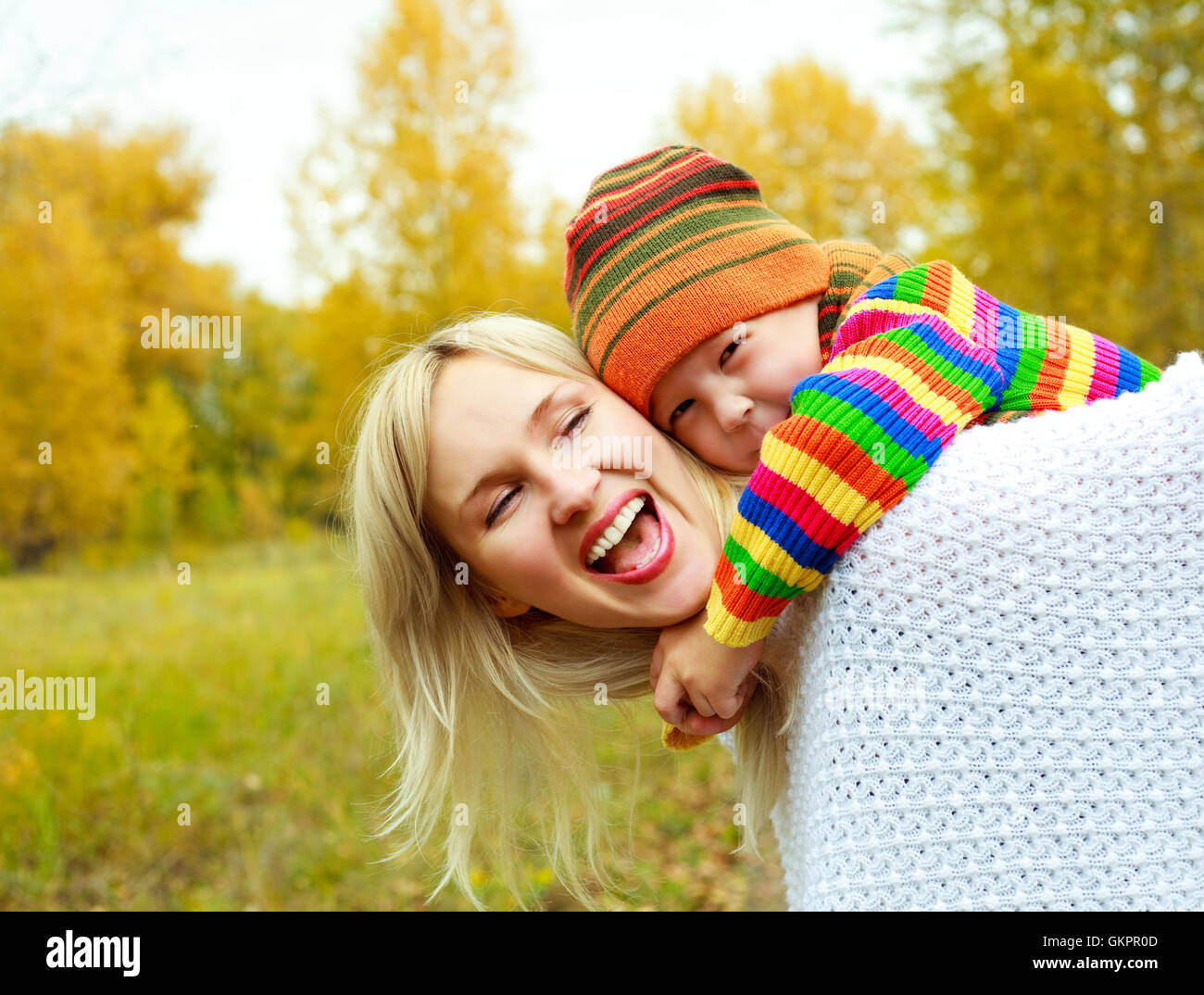 happy young mother and son in the autumn park Stock Photo - Alamy