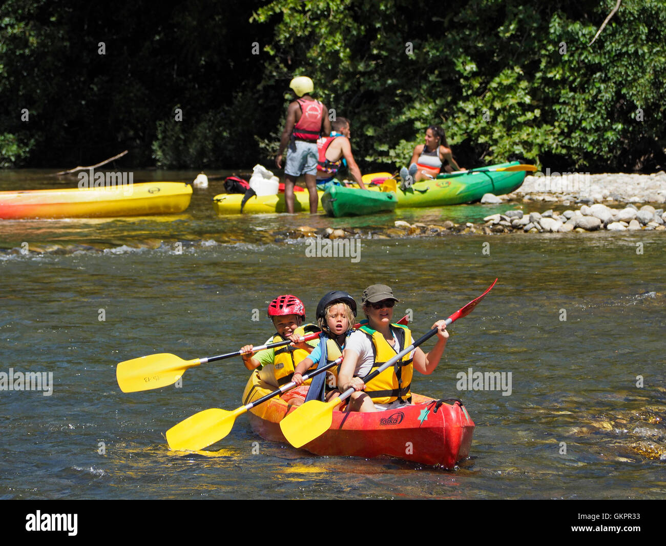 Mother with young children going on a canoeing adventure on the Herault river in the Cevennes region, southern France Stock Photo