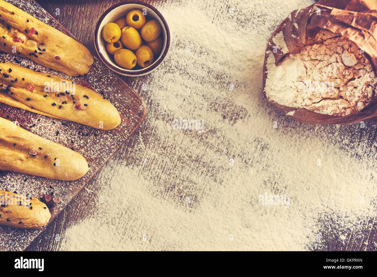 Vintage toned bread sticks ready for baking, space for text. Stock Photo