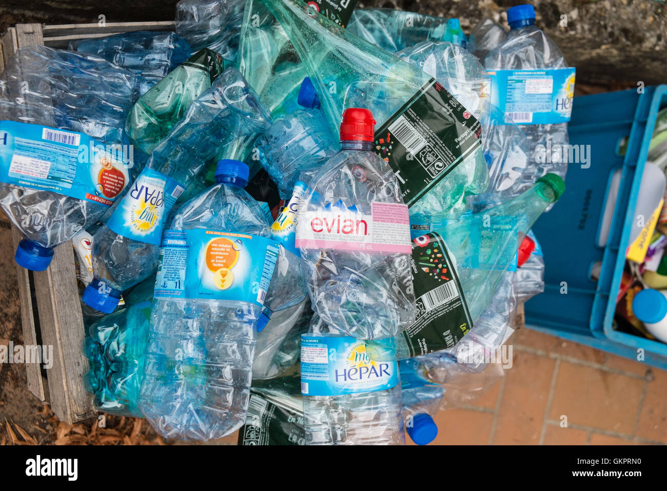 Used plastic water bottles in waste bin for recycling in village of