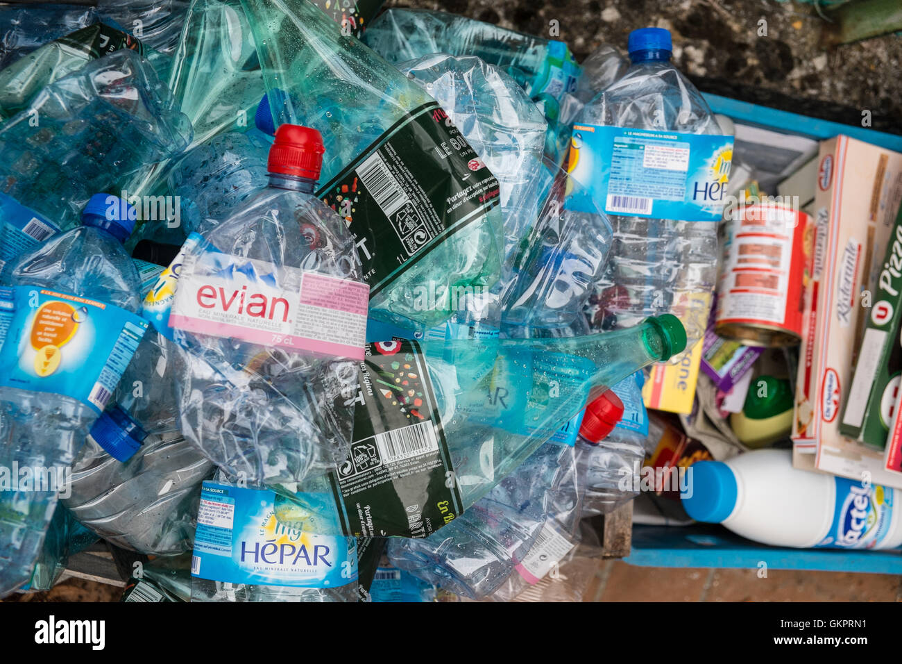 Used plastic water bottles in waste bin for recycling in village of