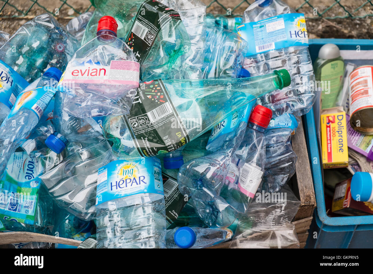Used plastic water bottles in waste bin for recycling in village of