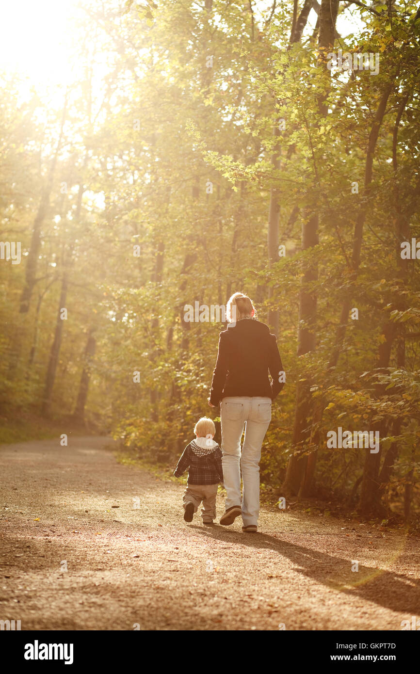Little boy with mother on outdoor walk in autumn park Stock Photo - Alamy