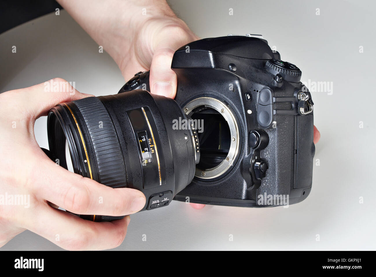 Photographer with big lens and digital SLR camera close-up Stock Photo