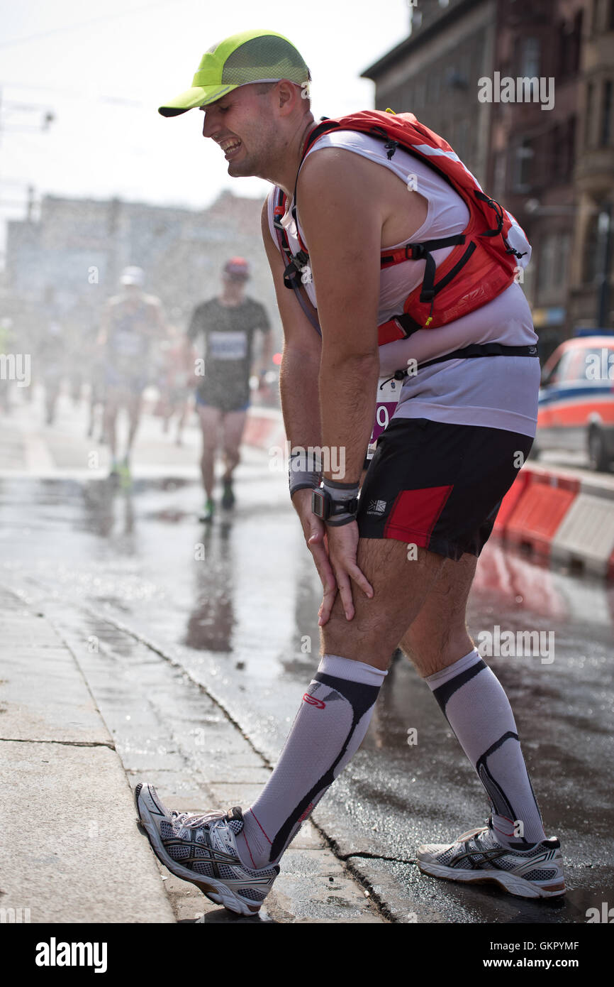 Runner whose leg caught cramp during 33. PKO Wroclaw Marathon. Stock Photo