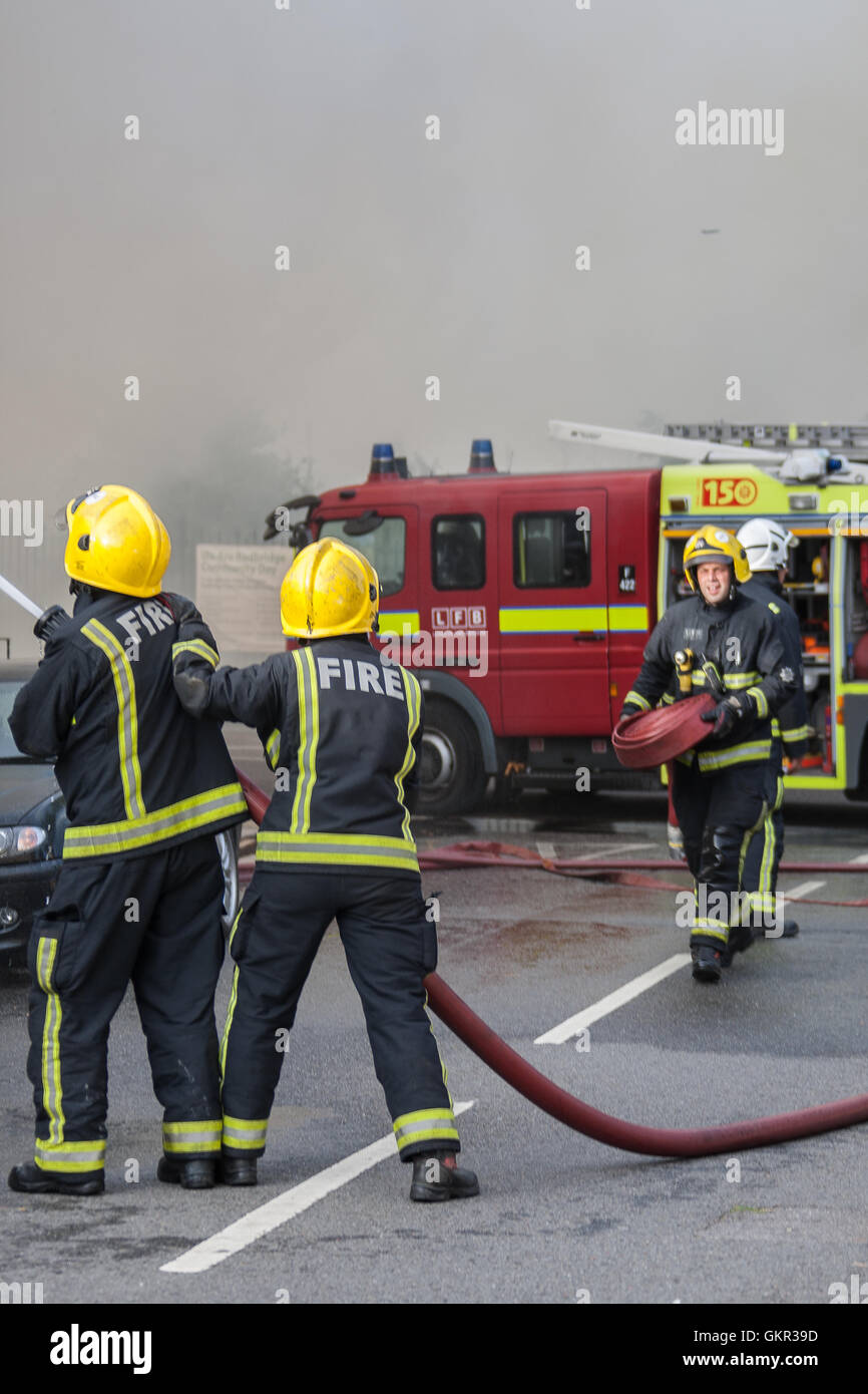 Firefighters tackling a blaze in a Hotel roof space in East London. Stock Photo