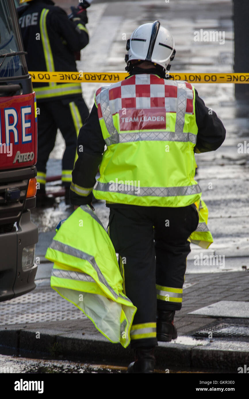 Fire Officer wearing Team Leader waistcoat at the scene of a fire in London. Stock Photo