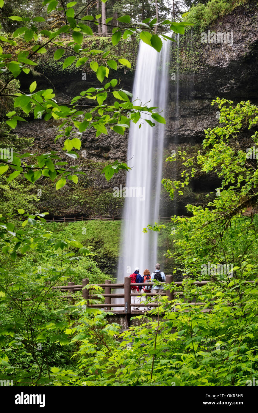 South Falls, with hikers on Trail of Ten Falls bridge; Silver Falls State Park, Oregon. Stock Photo
