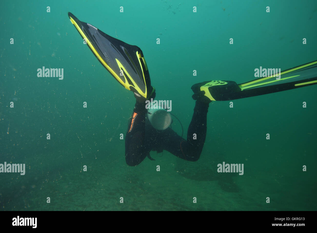 Scuba diver fins in murky water Stock Photo