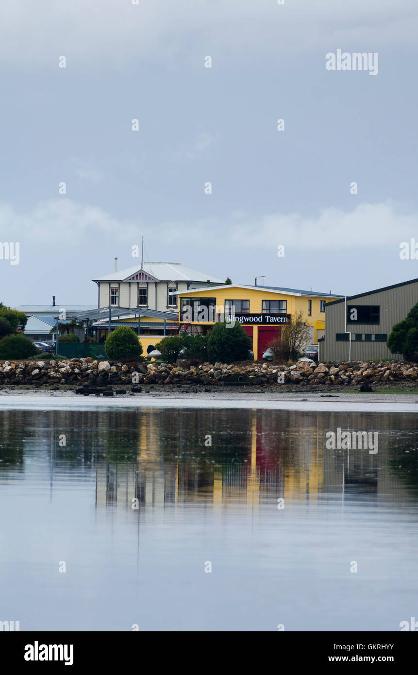 Shops and post office building across Aorere River estuary, Collingwood