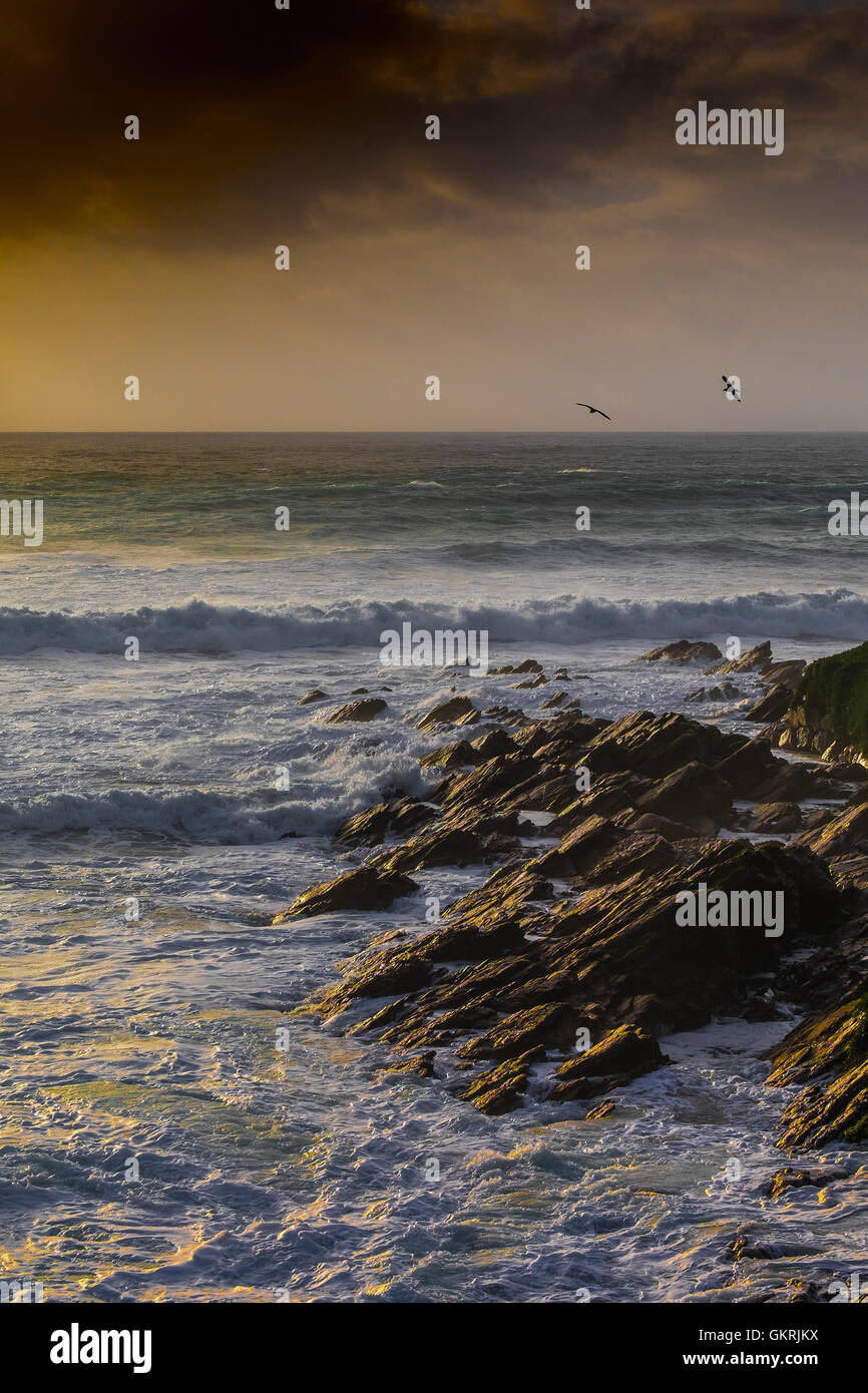 A stormy, windy sunset over The Headland in Newquay, Cornwall. Stock Photo