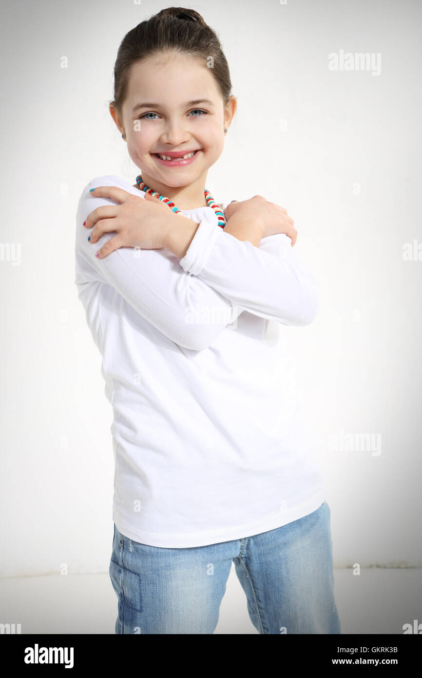 Portrait of smiling little girl with crossed arms Stock Photo - Alamy