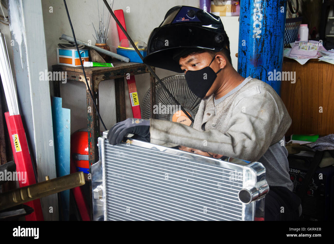 Thai people assembly radiator before use electricity welding for fix and solder radiator of car at local garage on July 7, 2016 Stock Photo