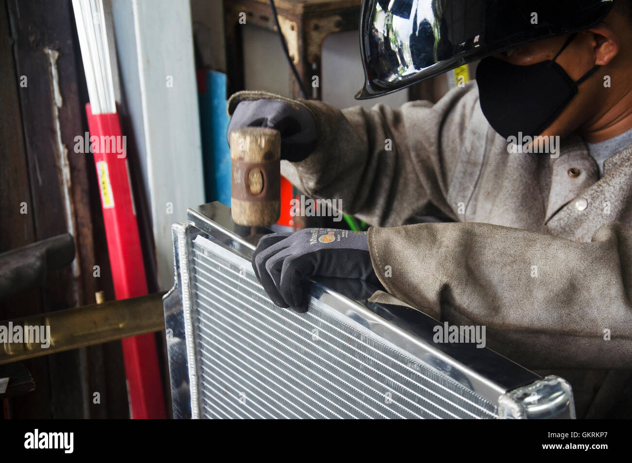 Thai people assembly radiator before use electricity welding for fix and solder radiator of car at local garage on July 7, 2016 Stock Photo