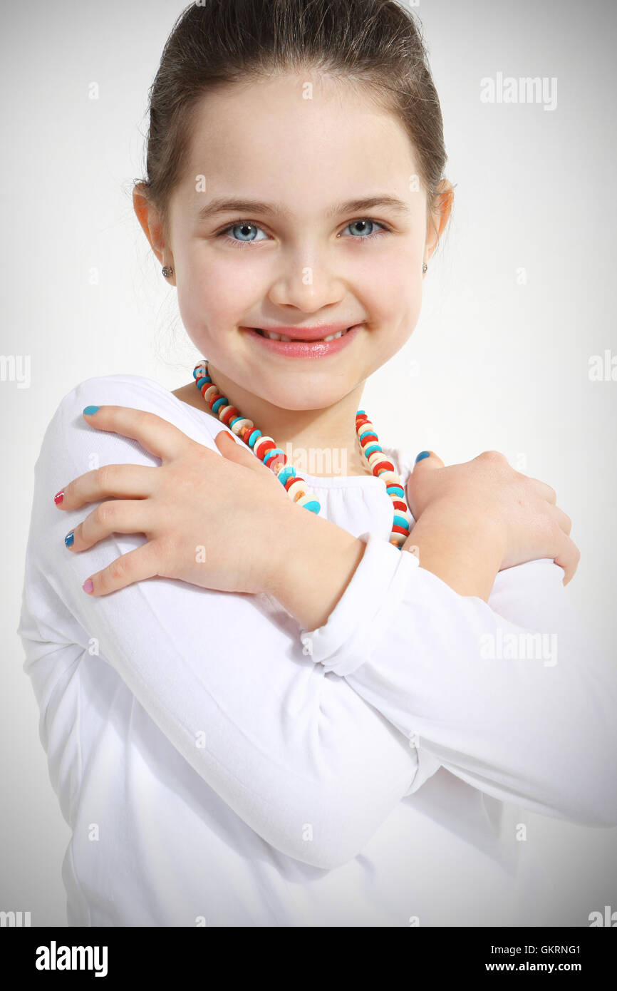 Portrait of smiling little girl with crossed arms Stock Photo - Alamy