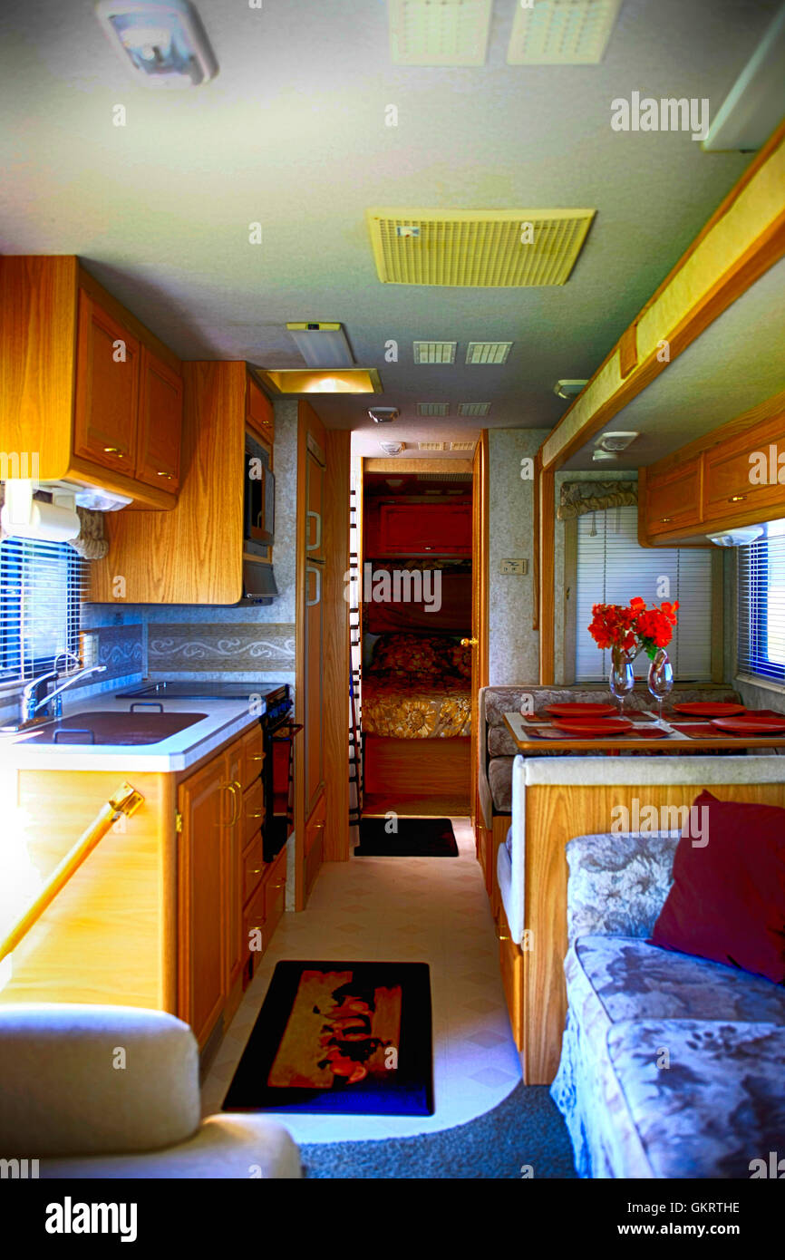 Interior view looking back towards the kitchen and bedroom in a 32ft class A motorhome set up at a park in Florida Stock Photo