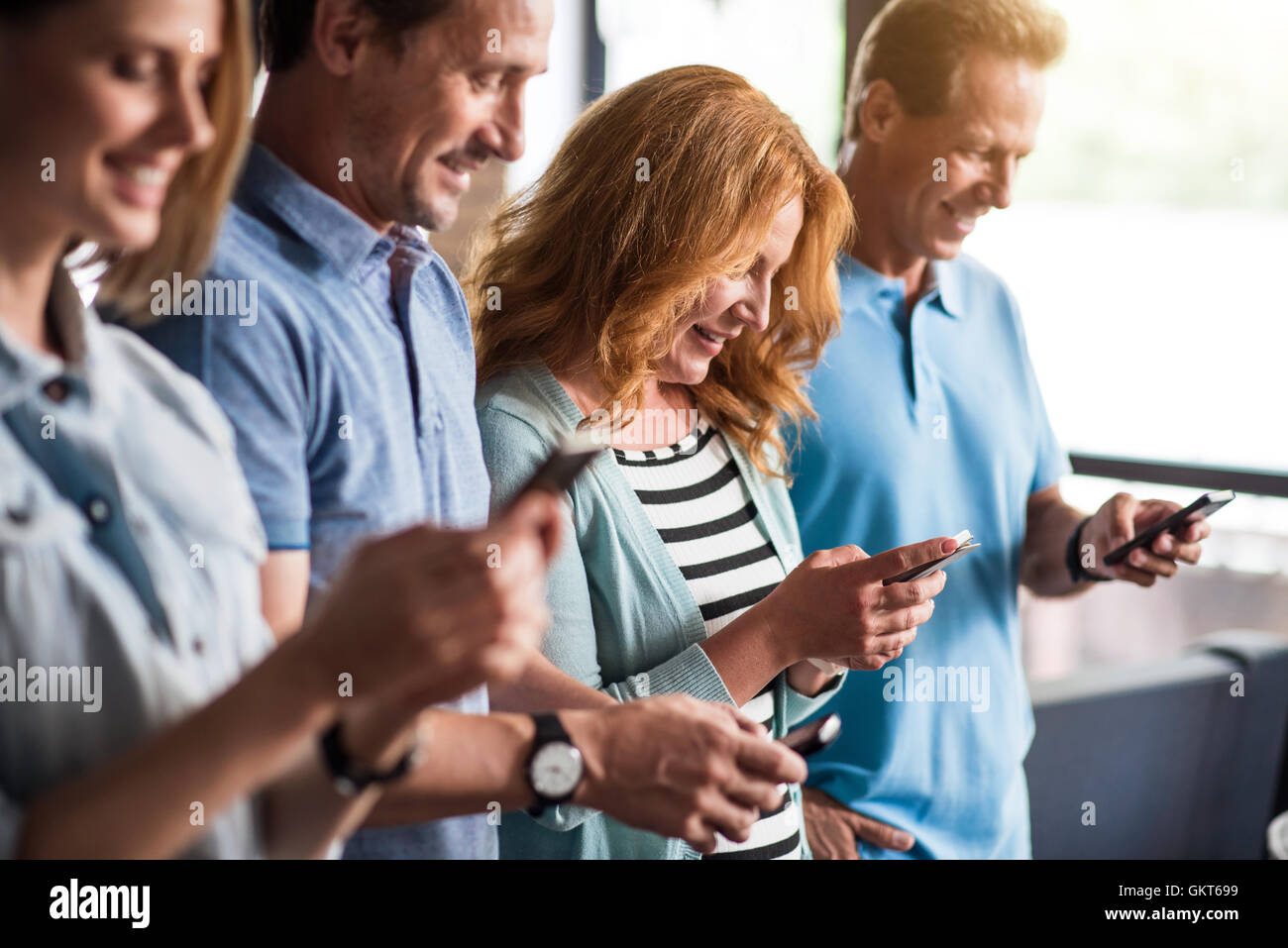 Busy people using smart phones Stock Photo