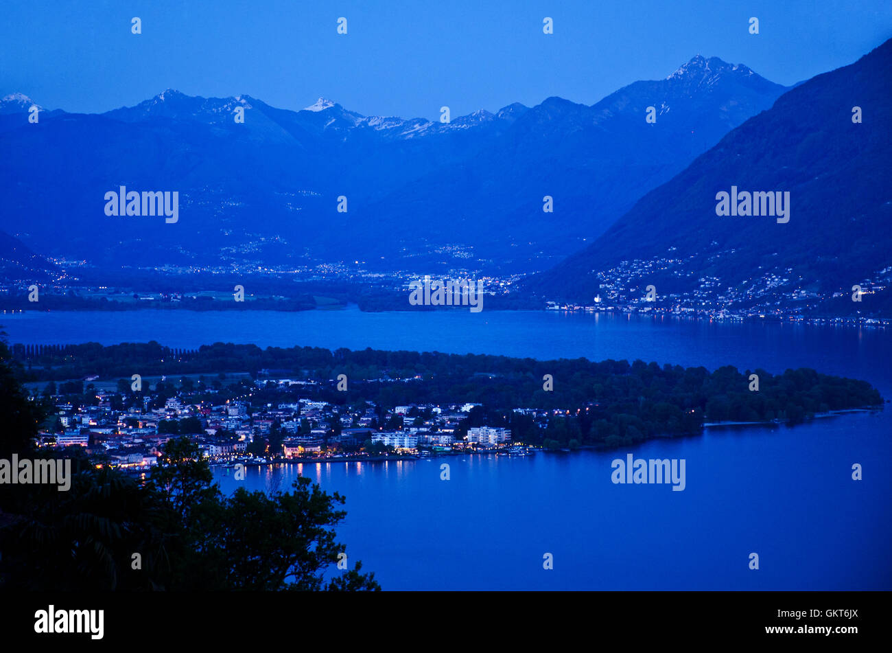 Evening over Lago Maggiore lake with town Locarno, Gamabarogno and Magadino plain (back), seen from Ronco, Ticino, Switzerland Stock Photo