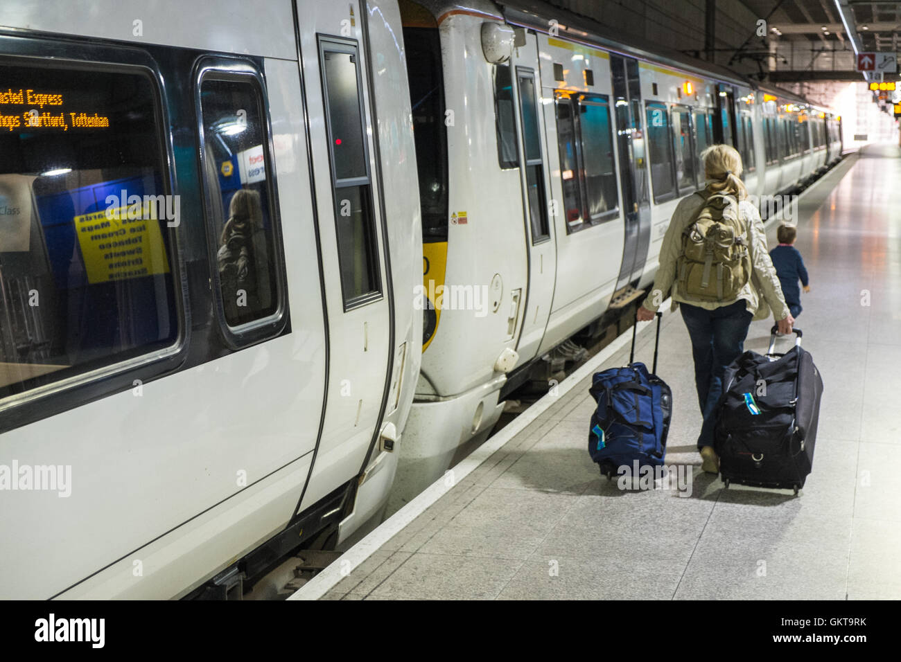 Stansted Express train,tourist,tourists,luggage,baggage,bags,on,platform at  Stansted Airport prior to heading to Liverpool Street,London,  Stock Photo - Alamy
