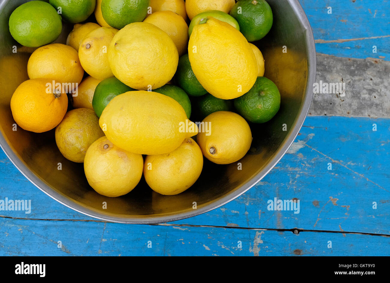 lemons and limes in metal bowl Stock Photo