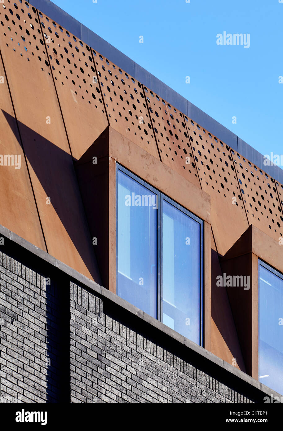 Detail of window showing painted brick and rusted steel mansard. 201 Borough High Street, London, United Kingdom. Architect: Stiff + Trevillion Architects, 2016. Stock Photo