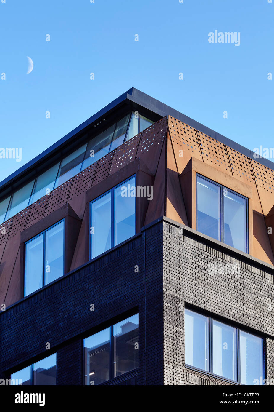 Detail of window showing painted brick and rusted steel mansard and the moon. 201 Borough High Street, London, United Kingdom. Architect: Stiff + Trevillion Architects, 2016. Stock Photo