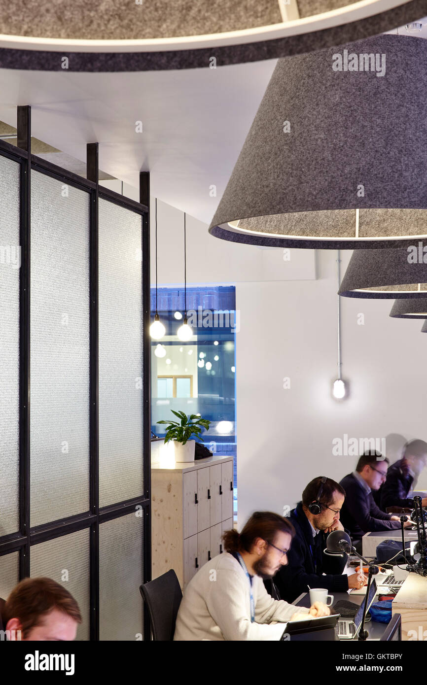 Work spaces with glass screens and people working. 201 Borough High Street, London, United Kingdom. Architect: Stiff + Trevillion Architects, 2016. Stock Photo