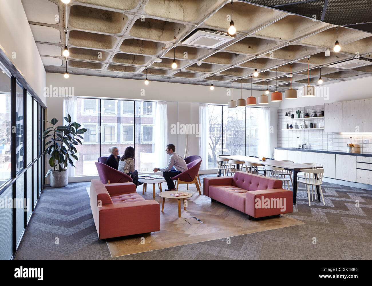 Kitchen and informal meeting area with coffered ceiling. 201 Borough High Street, London, United Kingdom. Architect: Stiff + Trevillion Architects, 2016. Stock Photo