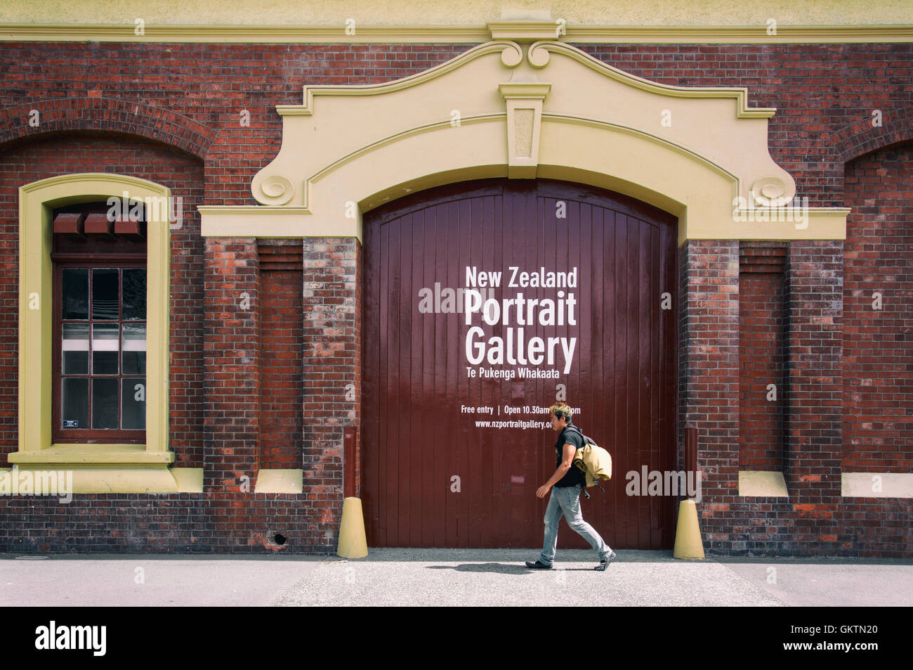 A man walking in front of classic old building at Customhouse Quay in Wellington CBD Stock Photo