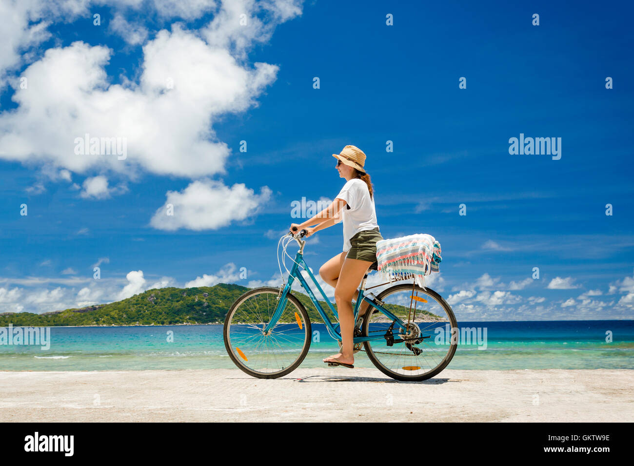 Woman on a bicycle ride along The Beach 