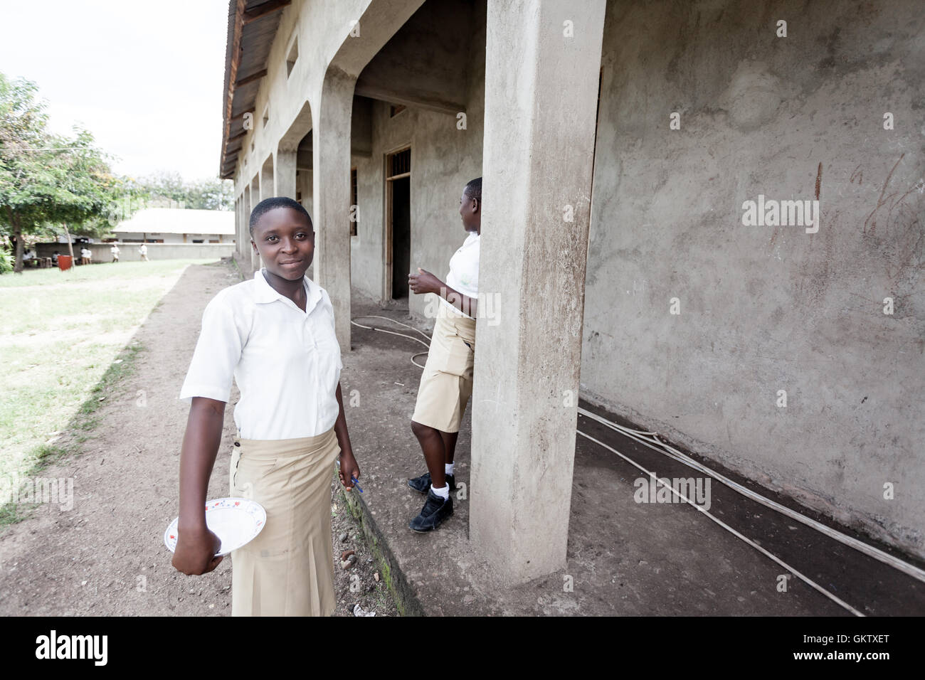 two girls enjoy a lunch break at a school in kasese, uganda Stock Photo