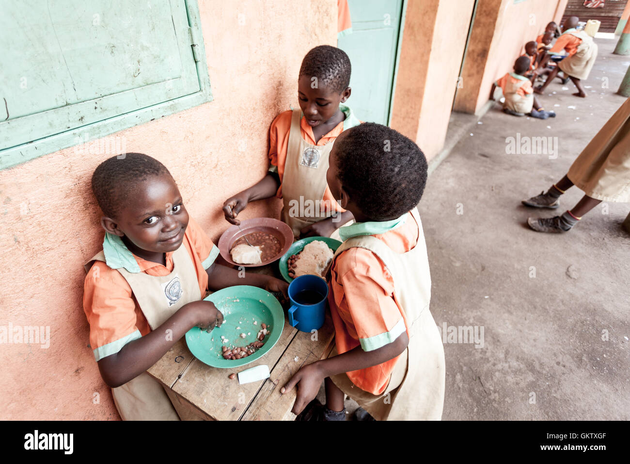 A group of girls eat lunch during a break from studies at a school in Uganda Stock Photo