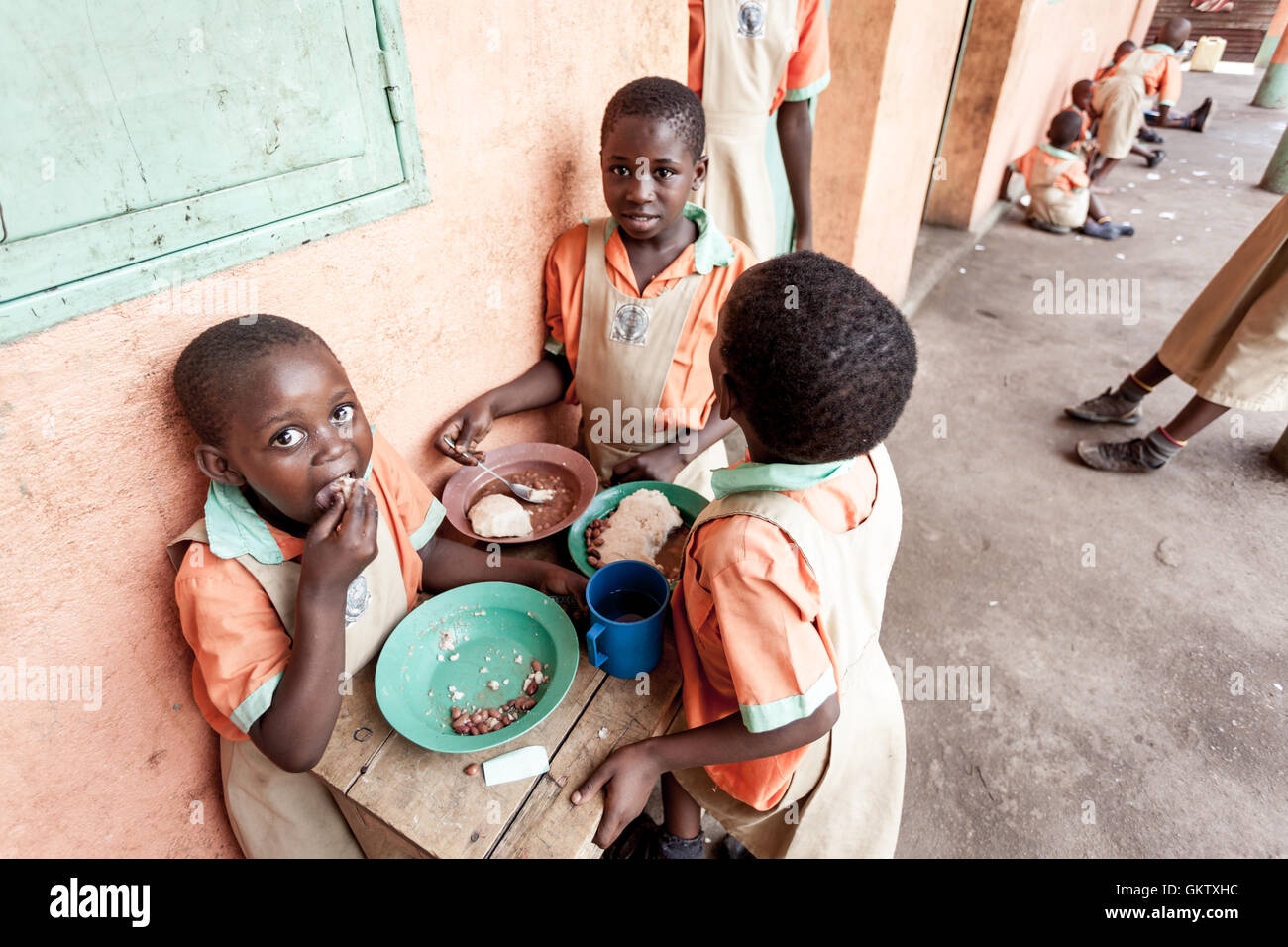 A group of girls eat lunch during a break from studies at a school in Uganda Stock Photo