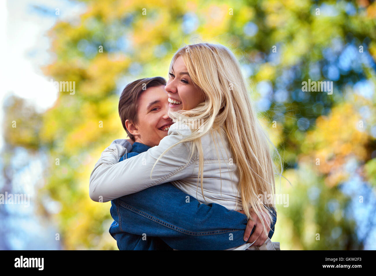 Young couple hugging and flirting in park Stock Photo - Alamy