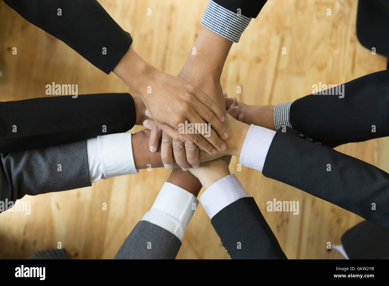 businesspeople in suit put their hand stack on top of each other ...