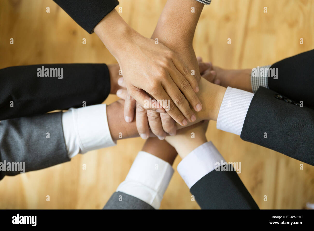 businesspeople in suit put their hand stack on top of each other ...
