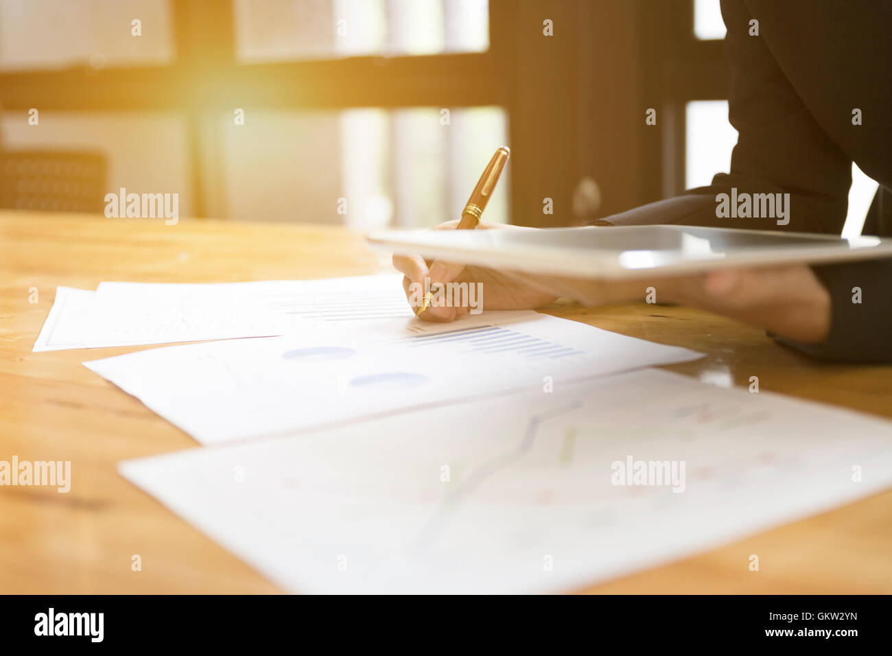 businessman in suit using tablet to analyze market analysis business chart document Stock Photo
