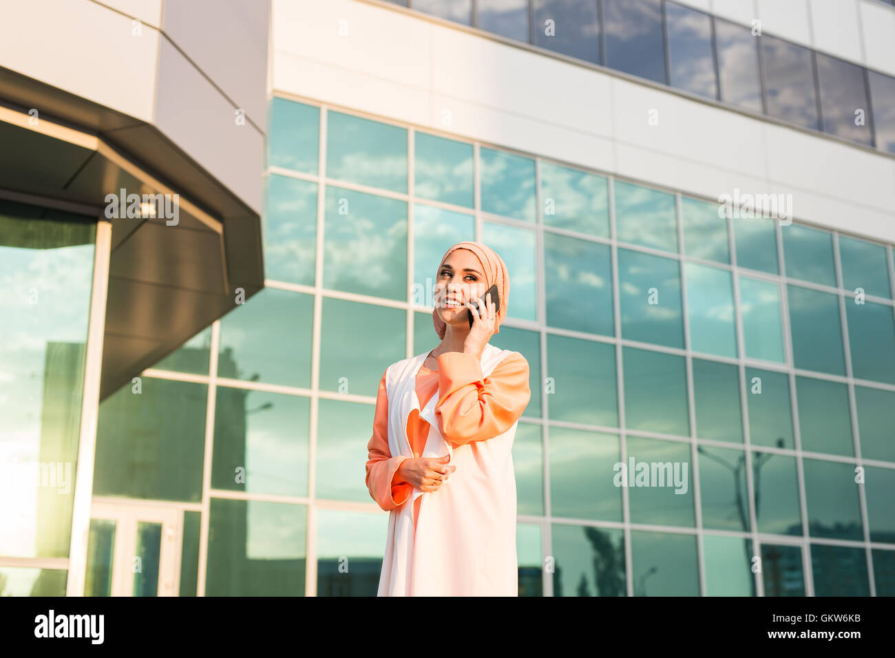 Young pretty muslim girl in hijab and mobile phone Stock Photo - Alamy