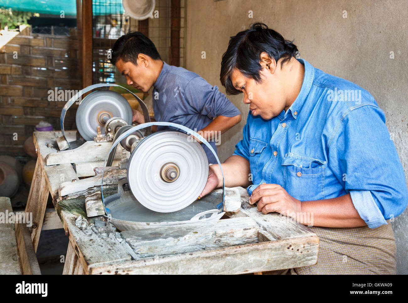 Local craftsman grinding and polishing jade on a wheel at the Jade