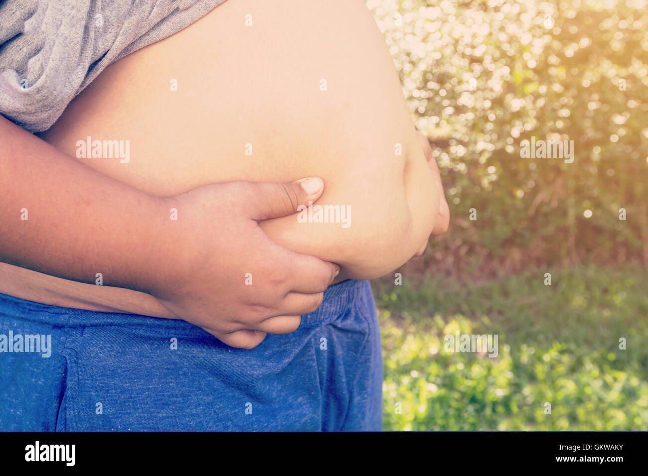 Boy fat and unhealthy with natural ilght vintage background. Stock Photo