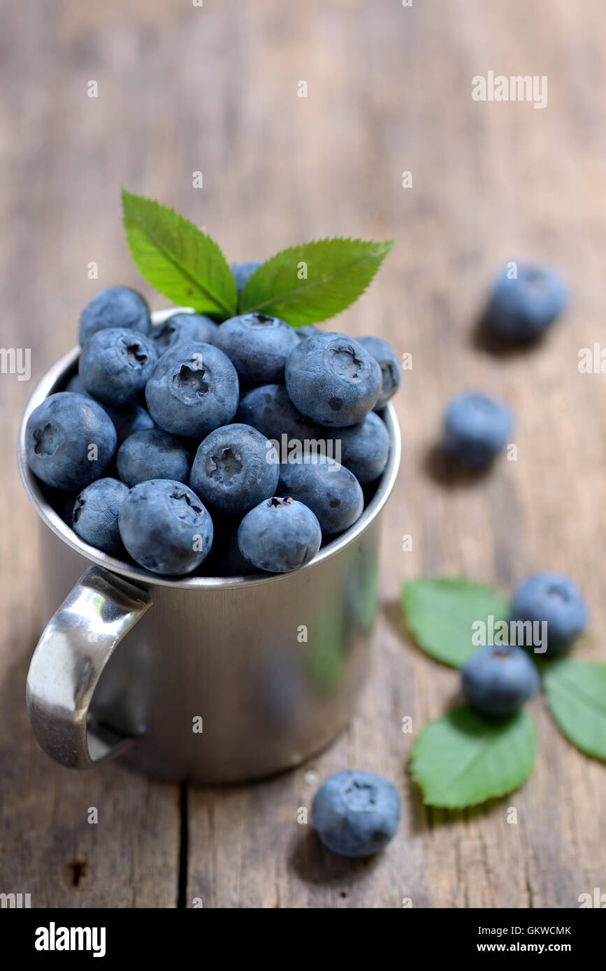 Blueberries in mug on a wooden background Stock Photo