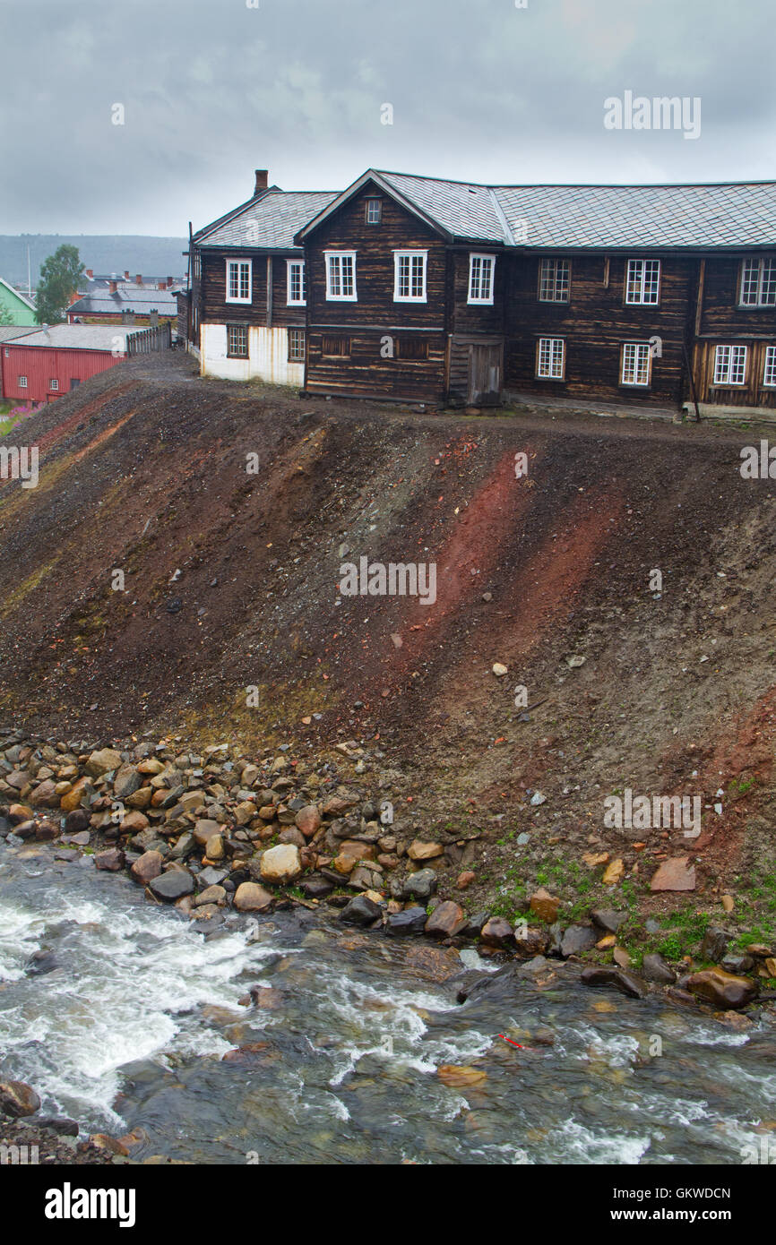 View of the historic Norwegian mining town Røros, wooden houses and slag heaps, remainders of the copper industry Stock Photo
