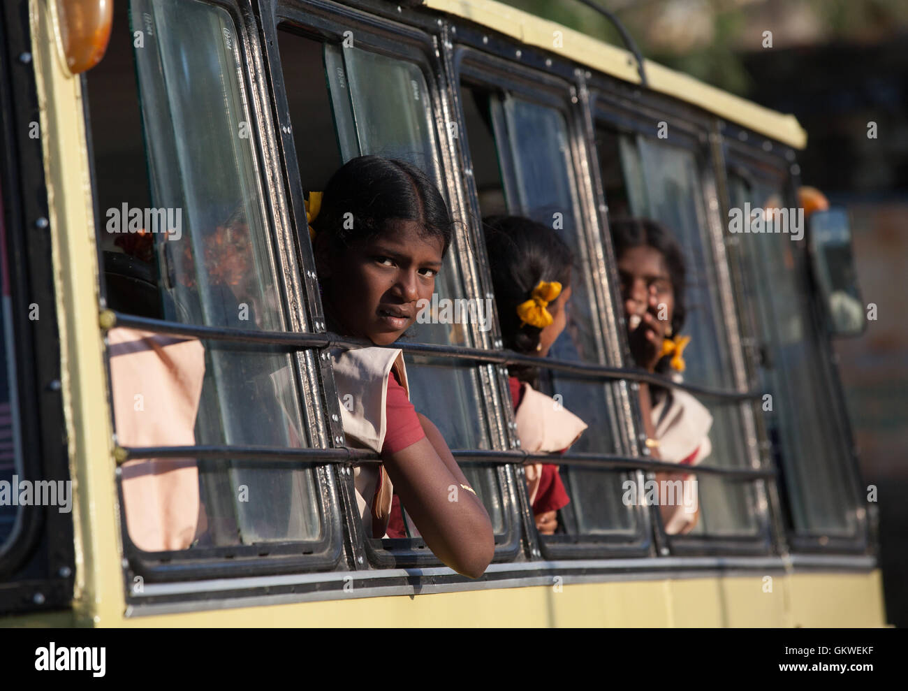 Indian school girls looking out of bus window. Stock Photo
