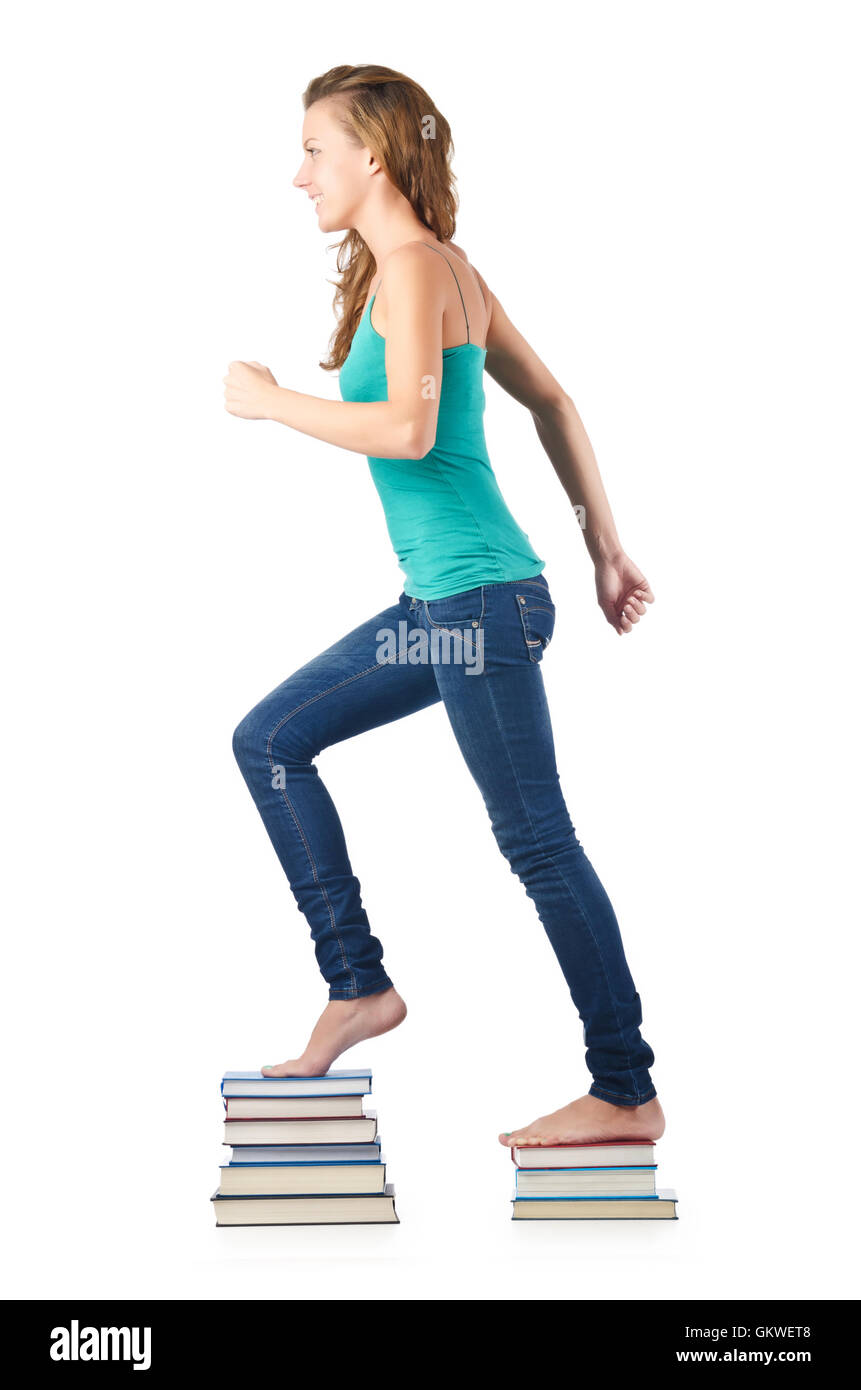 Student sitting on stack of books Stock Photo - Alamy