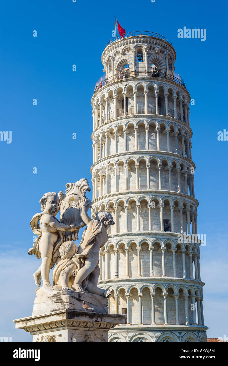 Fontana dei Putti with leaning tower in background in Piazza dei Miracoli square of Pisa. Tuscany, Italy. Stock Photo