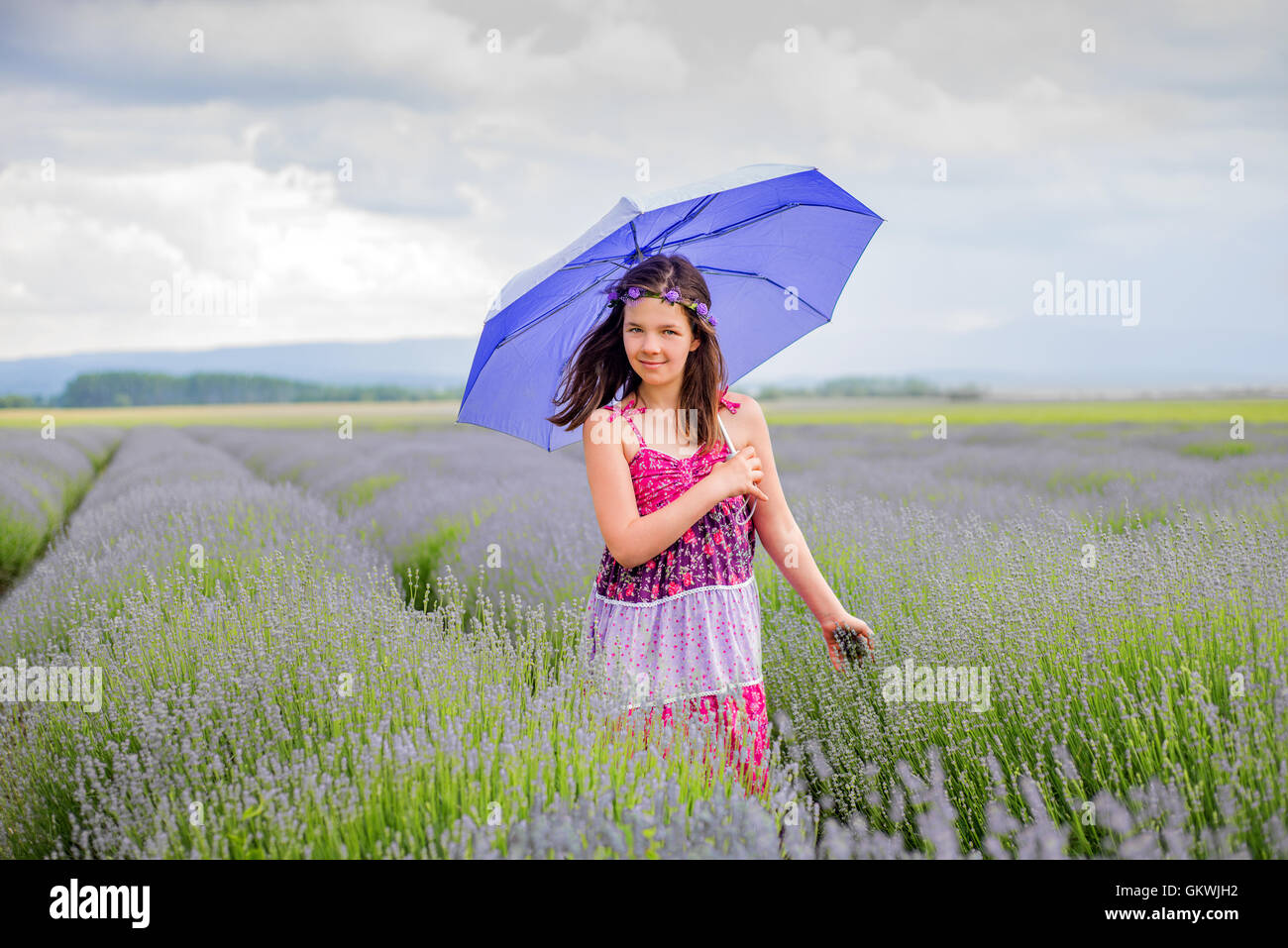 Happy girl holding umbrella hi-res stock photography and images - Alamy