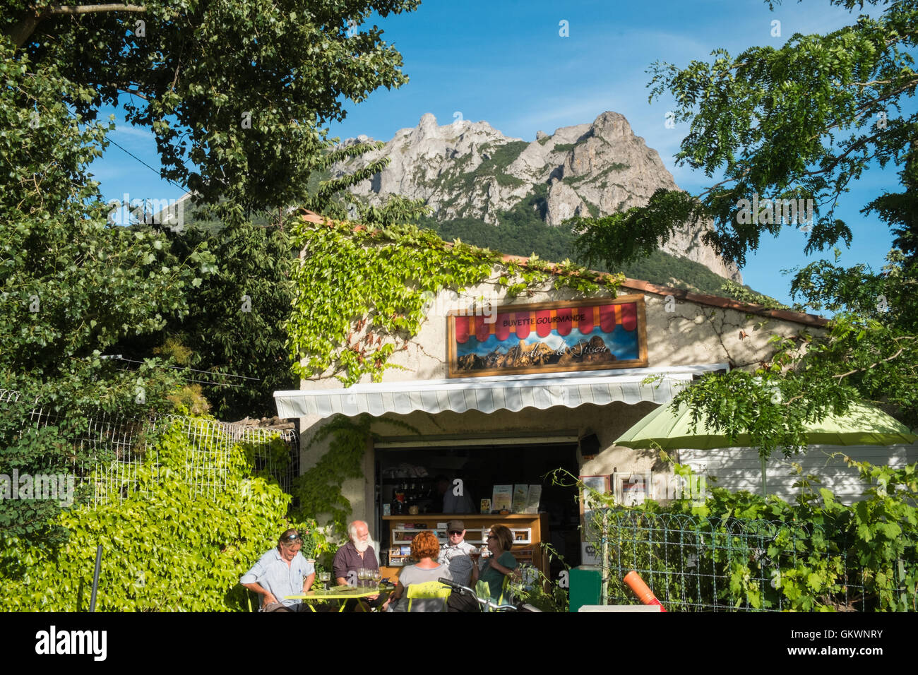 Bugarach Mountain in background,backdrop and guests sitting at small cafe in Bugarach,Aude Province,South of France. Stock Photo